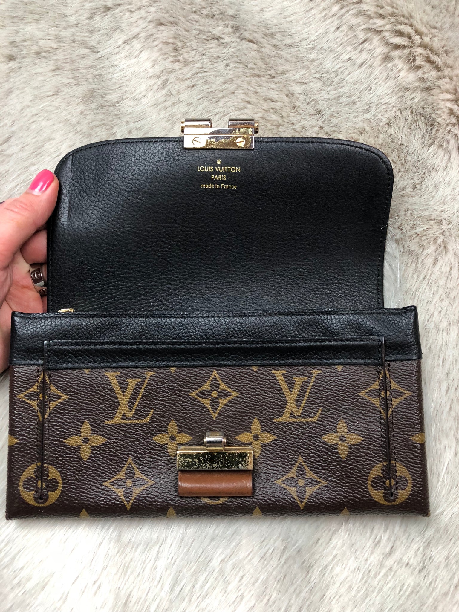 LOUIS VUITTON ELYSEE MONOGRAM WALLET, with gold tone clasp at the